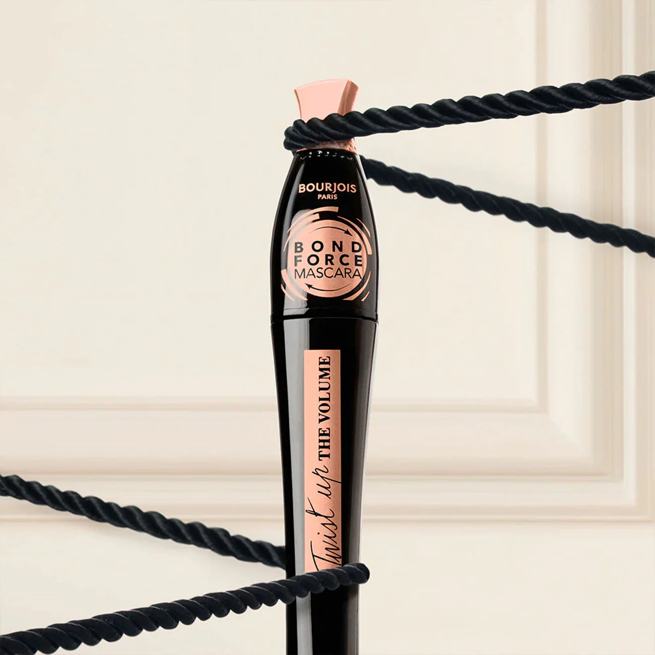 Bourjois Bond Force Mascara with black rope on a beige background
