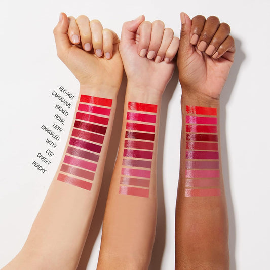 Swatches of Maybelline Vinyl Ink Lipstick on different skin tones, displaying a range of colors.