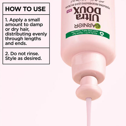 Pink bottle of Garnier Ultra Doux hair product with usage instructions on a white background