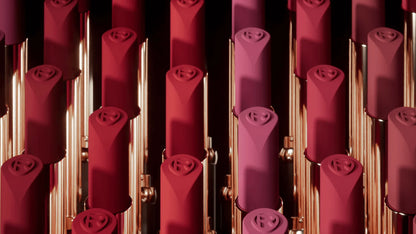 L'Oréal Paris Red lipsticks with rose designs on a black background