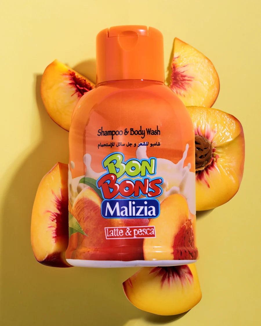 Bon Bons Malizia shampoo and body wash bottle surrounded by peach slices on a yellow background