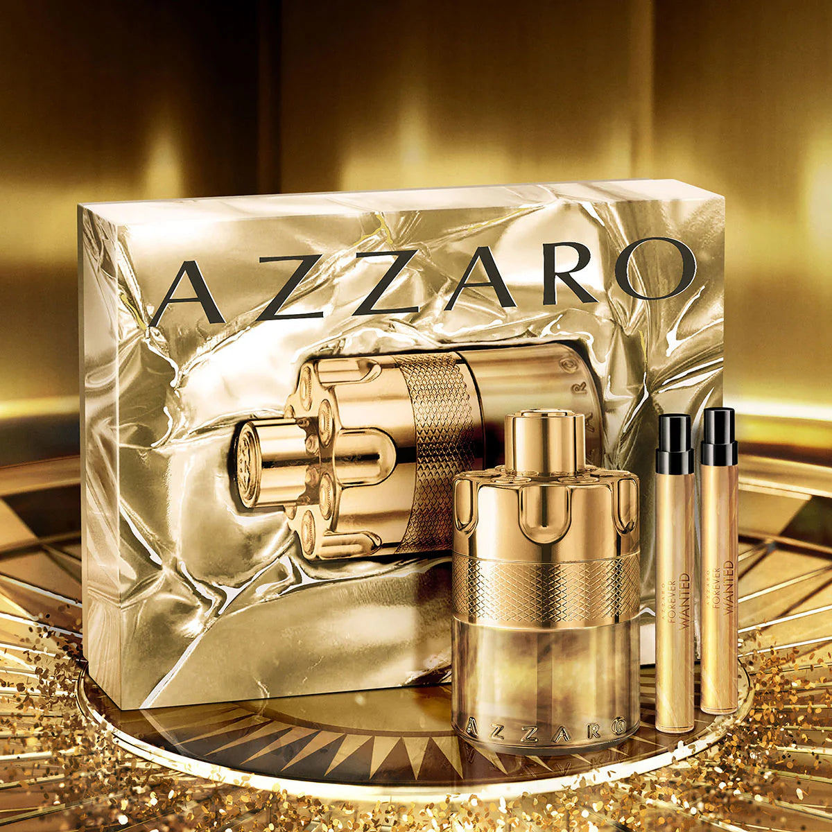 Gold Azzaro perfume set on a reflective surface with a gold background