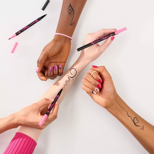 Hands with pink nail polish holding an Essence eyeliner against a white background