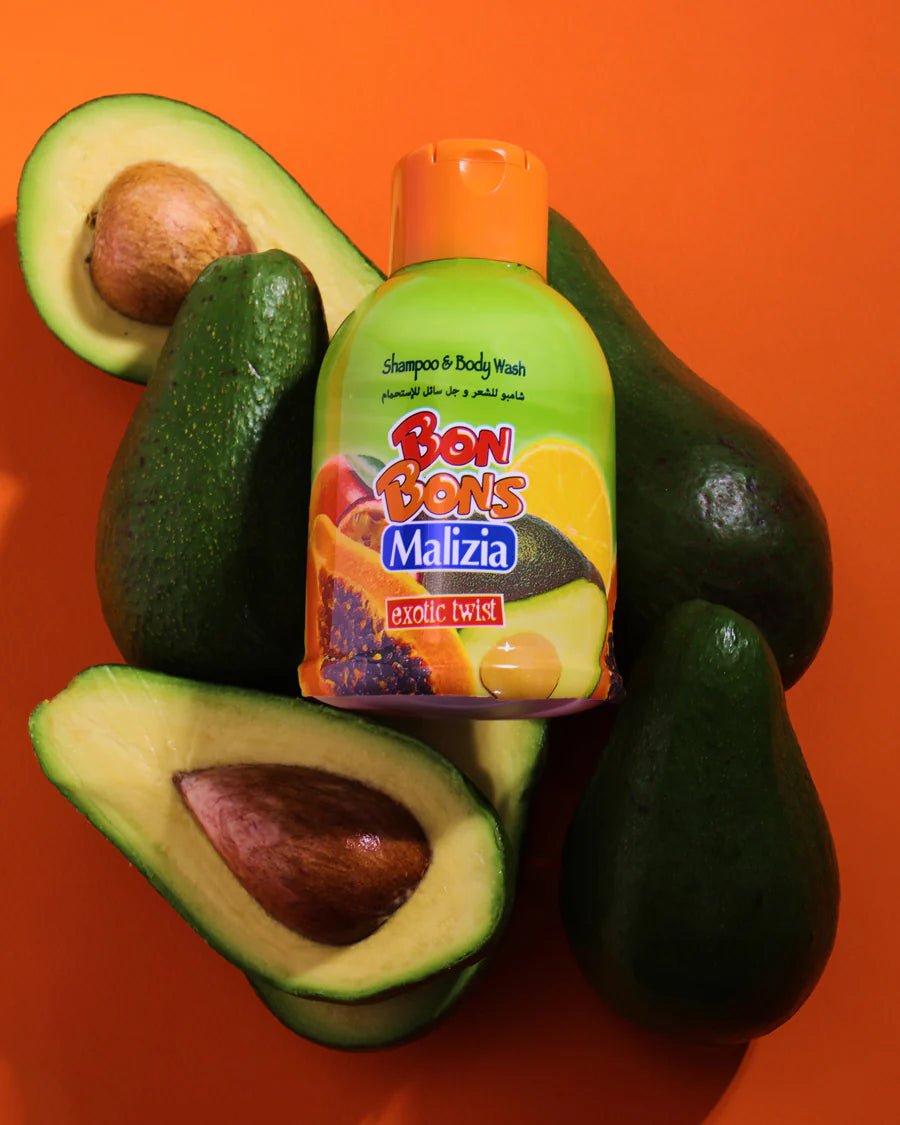Bon Bons Malizia shampoo bottle surrounded by avocados on an orange background