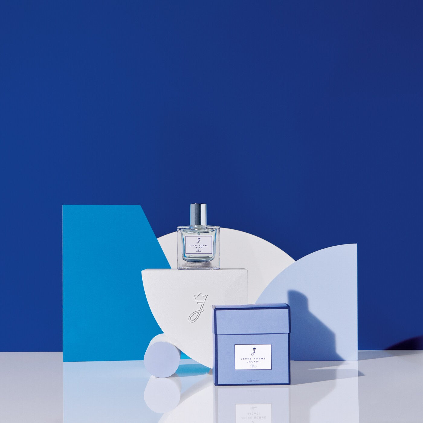 Perfume bottle and packaging on a blue and white abstract background
