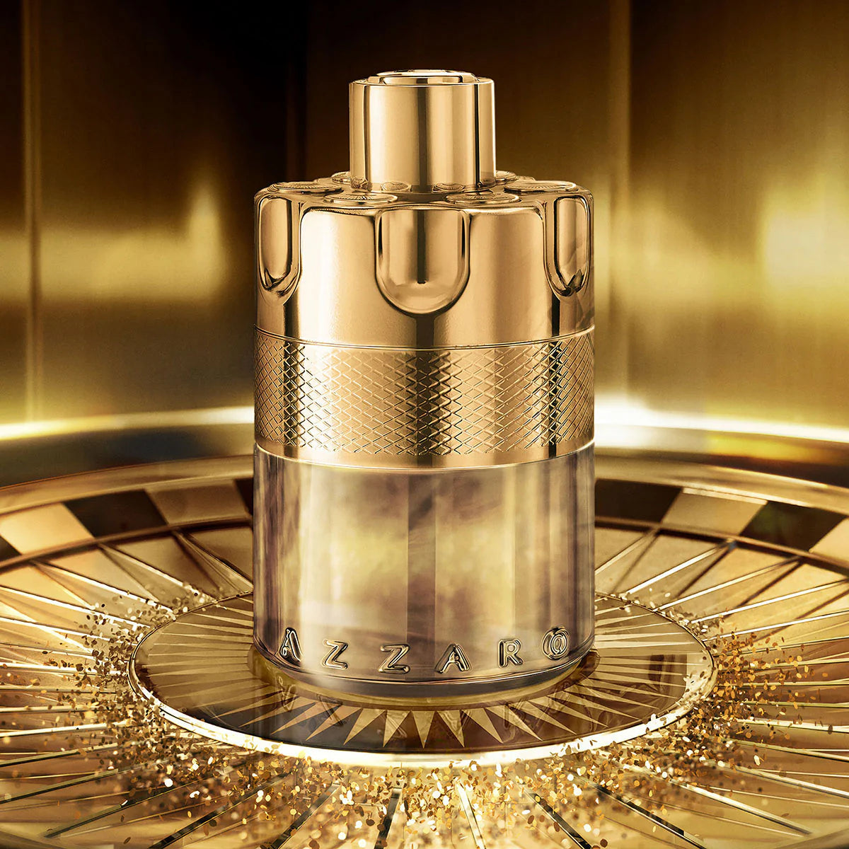 Gold Azzaro perfume bottle on a reflective surface with a blurred background