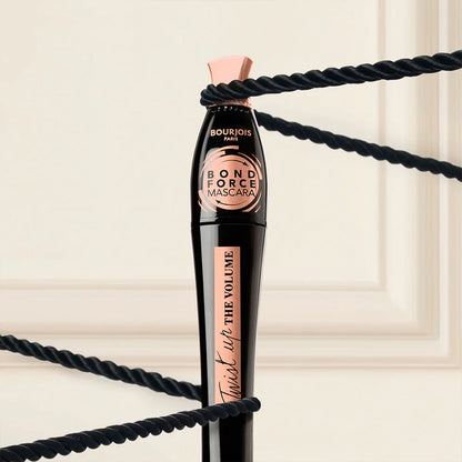 Bourjois Bond Force Mascara with black rope on a beige background
