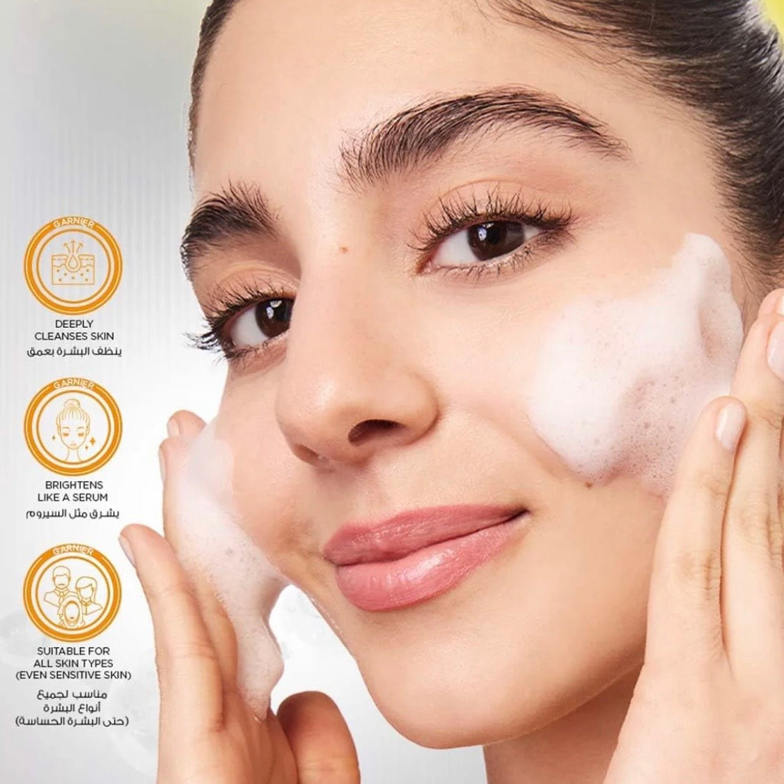 Woman applying facial cleanser with product features on the left side.