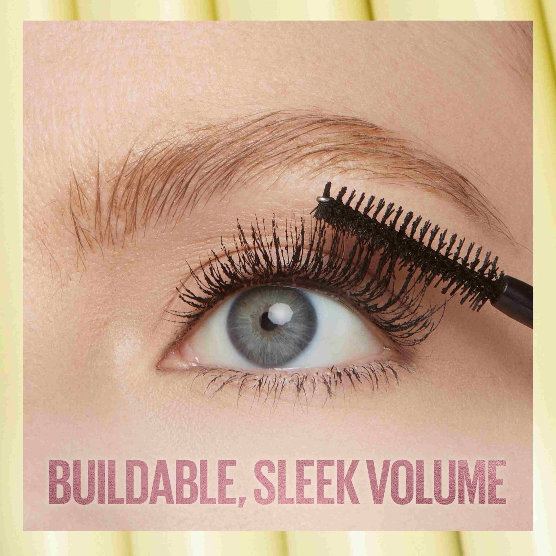 Eyelash product being applied to an eye with text 'Buildable, Sleek Volume' on a yellow background