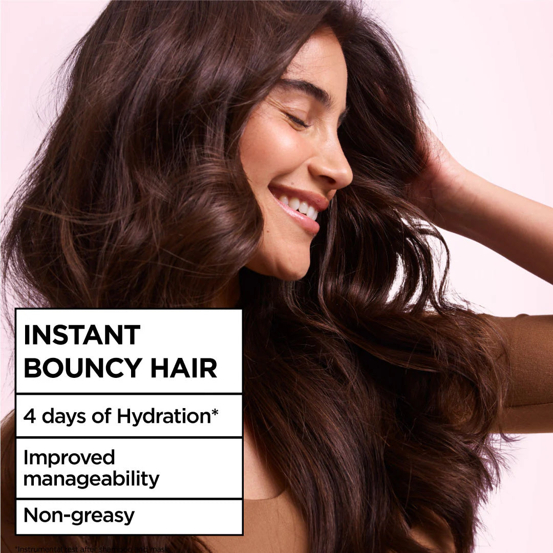 Woman with voluminous hair against a pink background with text about hair care product benefits.
