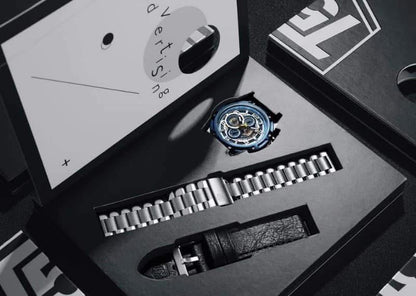 Watch with metal band in open black box, brand logo visible