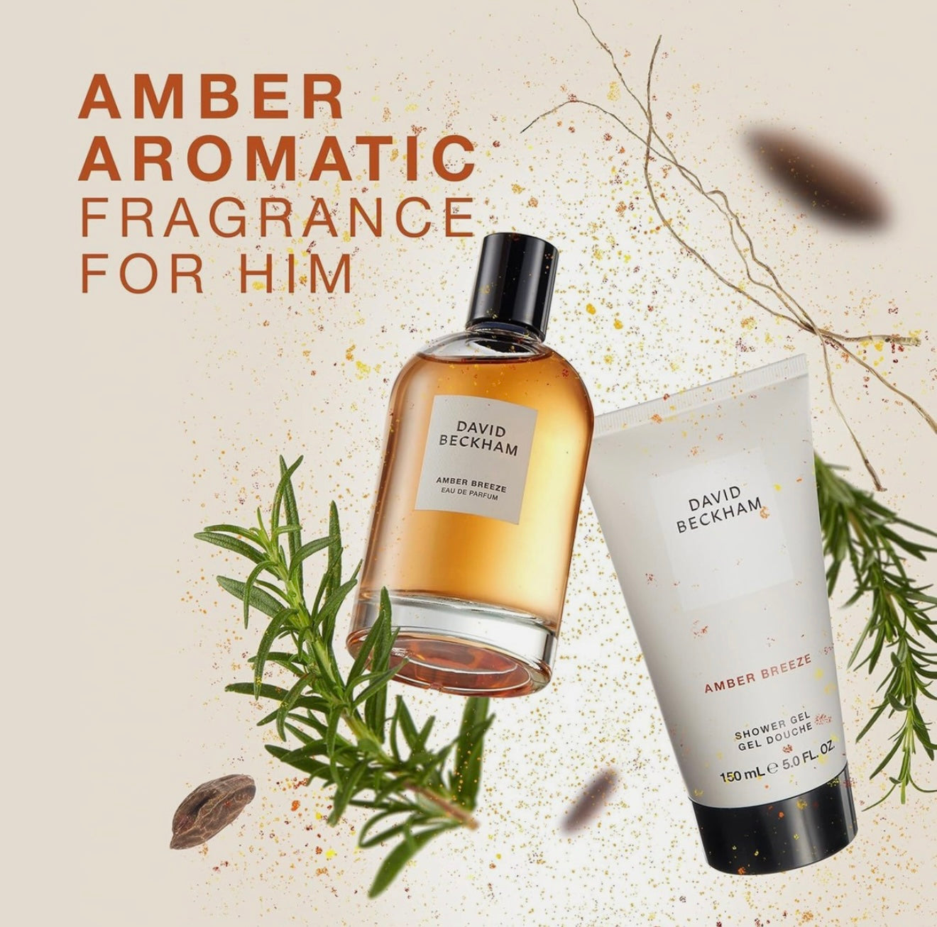 David Beckham Amber Breeze Aromatic fragrance bottle and shower gel with green leaves on a beige background
