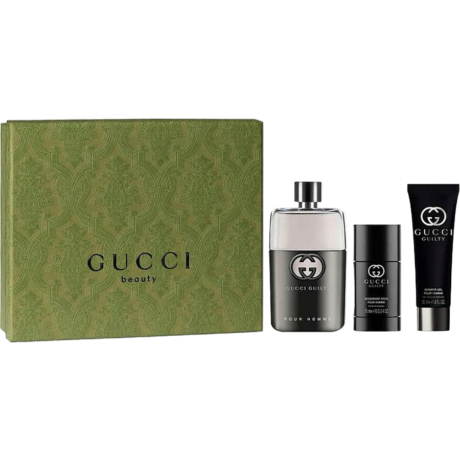 Gucci Guilty beauty product set including a perfume bottle, a stick, and a tube on a white background