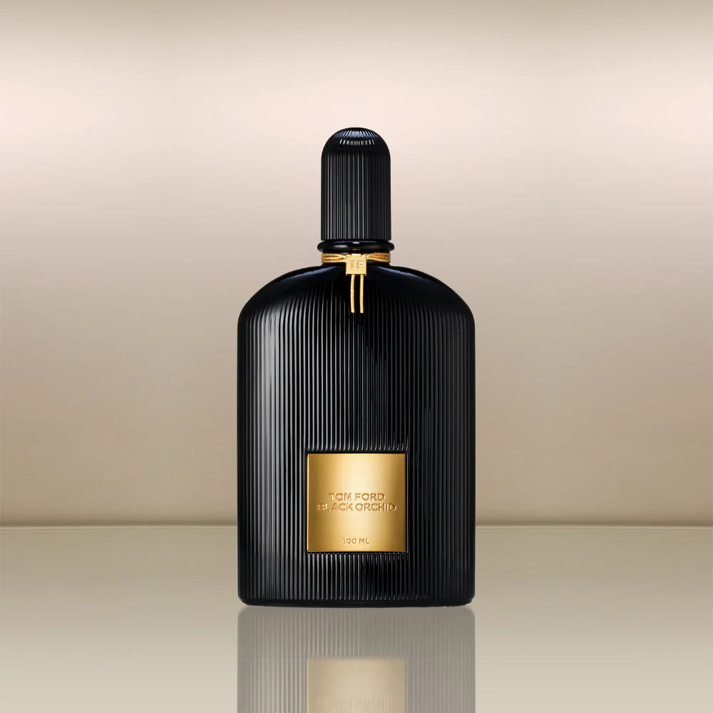 Black and gold Tom Ford Black Orchid perfume bottle on a beige background