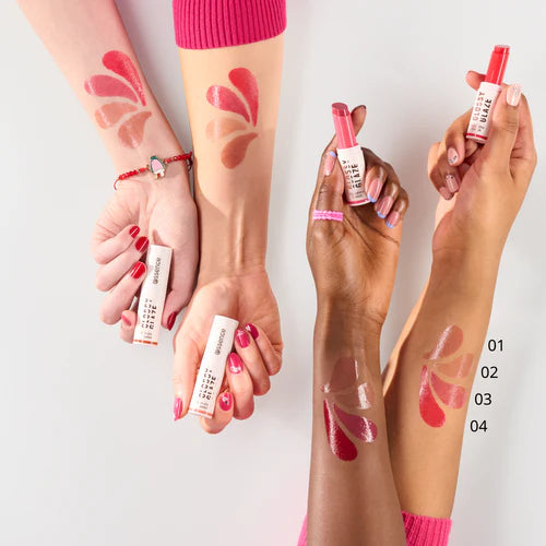 Lipstick swatches on hands with visible brand names against a white background