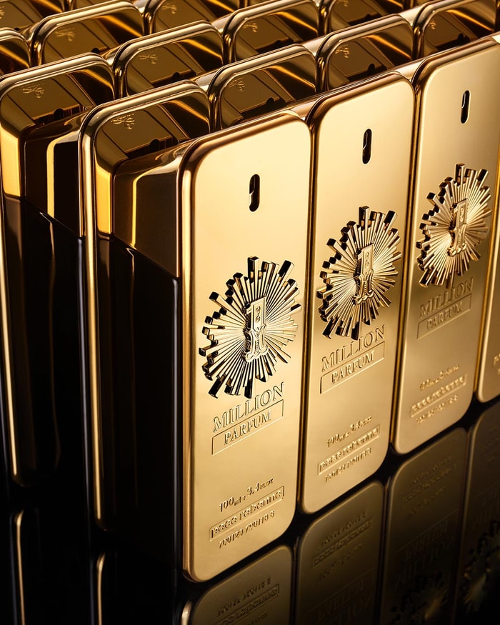 Gold perfume bottles of Paco Rabanne 1 Million with a prominent brand logo on a reflective surface