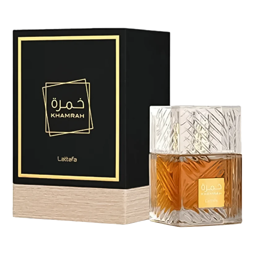 A Khamrah perfume bottle from Lattafa with a clear liquid inside, next to its black box with gold accents and the brand name 'Lattafa' written on it.