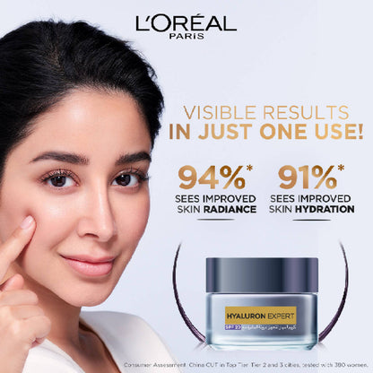 L'Oreal Paris ad with a woman touching her face and showing product benefits.