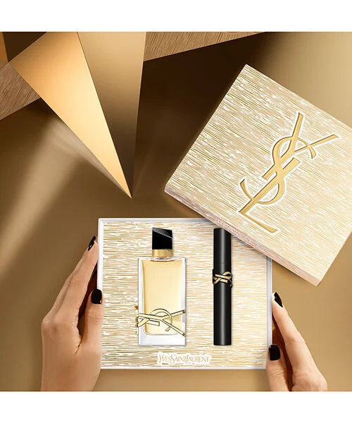 YSL beauty set with perfume and mascara product in a decorative box on a beige background