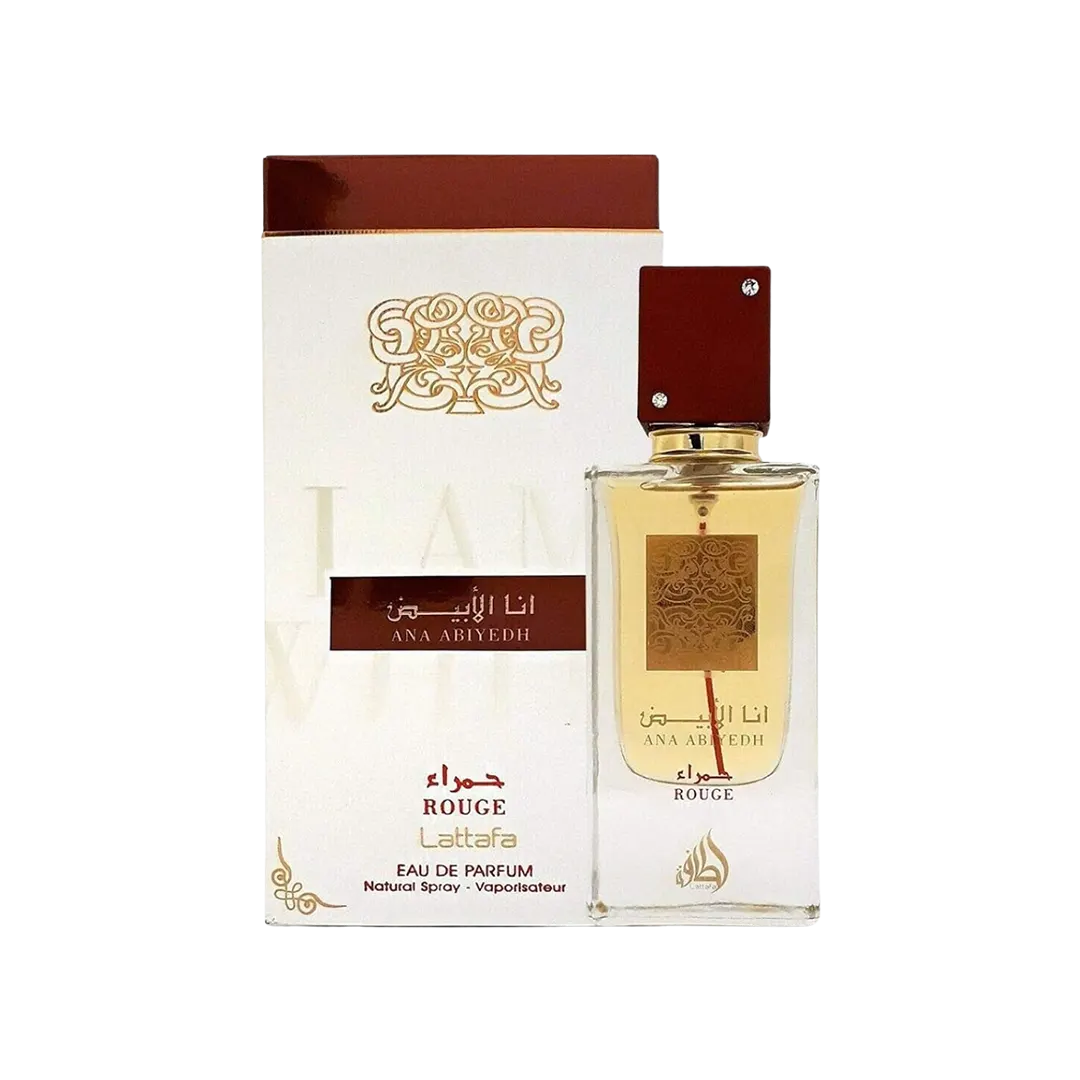 A bottle of Lattafa Ana Abiyed Rouge Eau De Parfum Unisex, with its packaging box. The bottle is clear, showcasing the fragrance, and the box has elegant red and gold design elements.